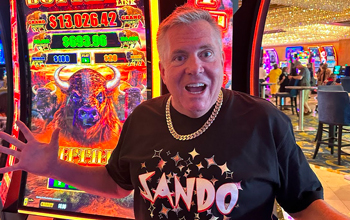 Vegas Morrow standing in front of a buffalo slot machine at a casino venue